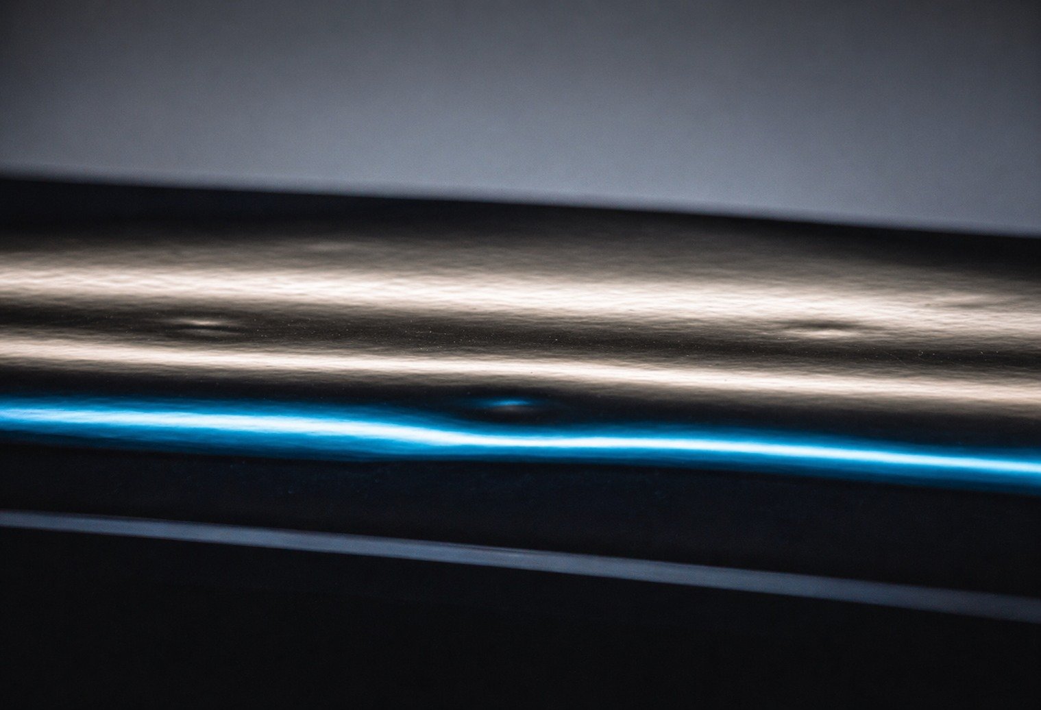 Reflection board showing hail dent distortion on a vehicle panel